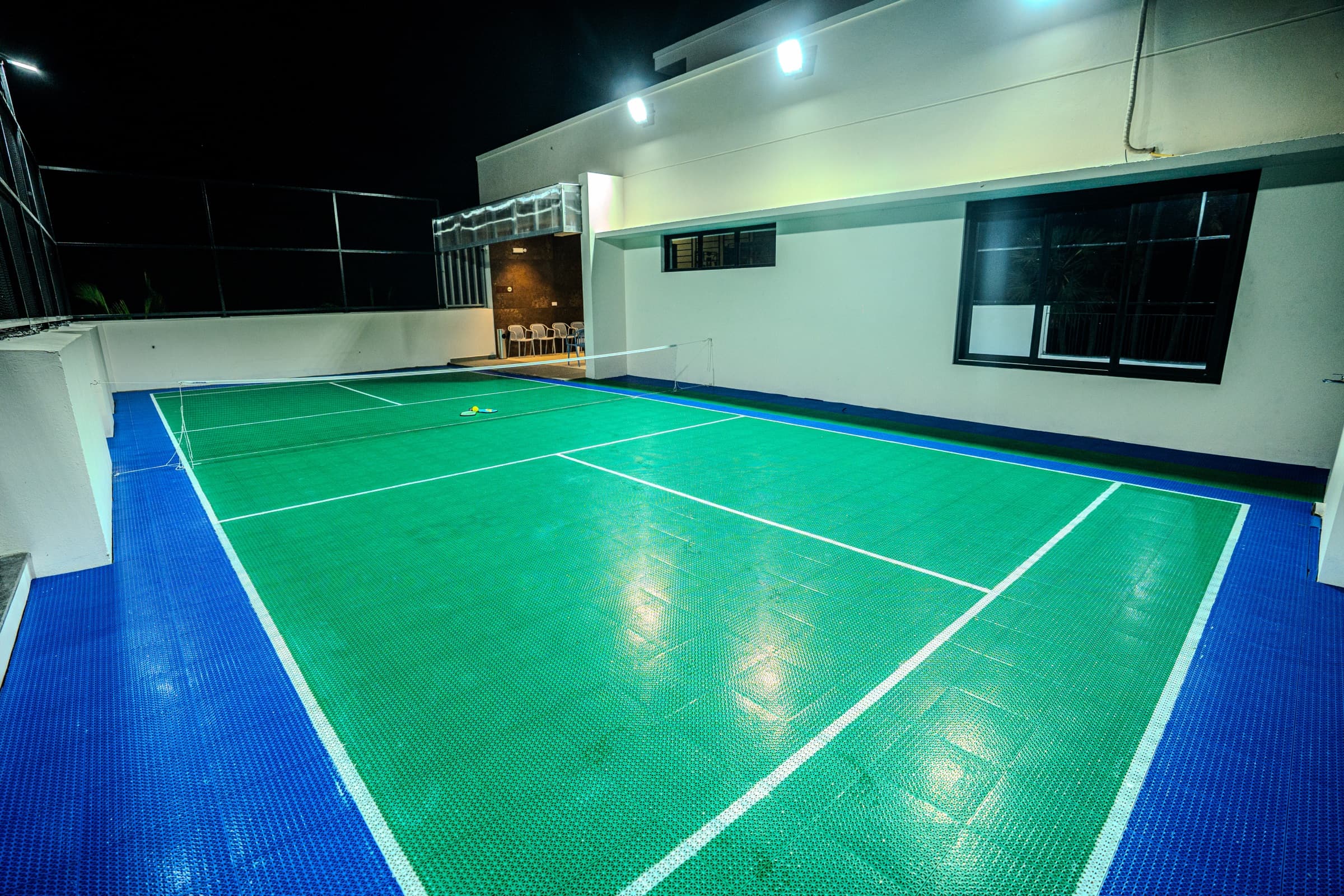 Floodlit pickleball court beside the villa
